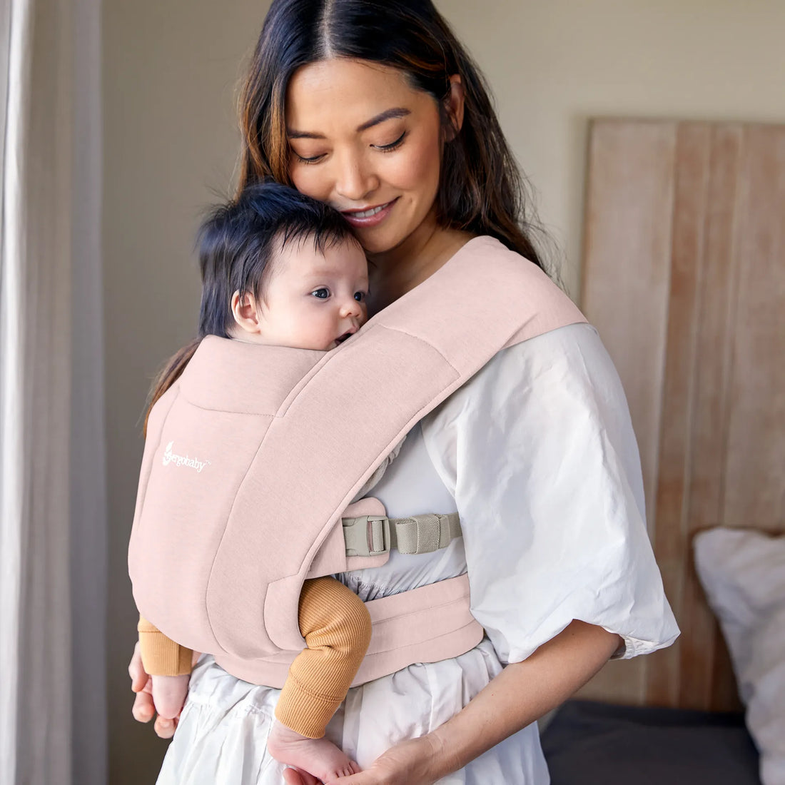 Frau mit Baby in Babytrage rosa Babytrage