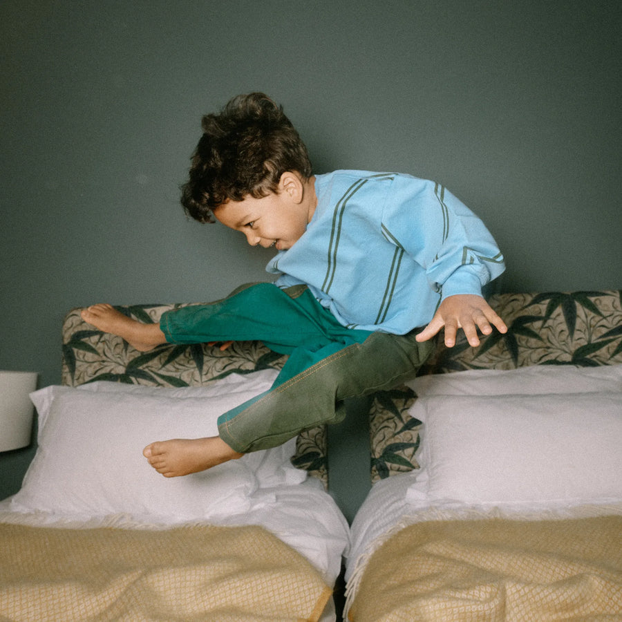 Toddler jumping on the bed
